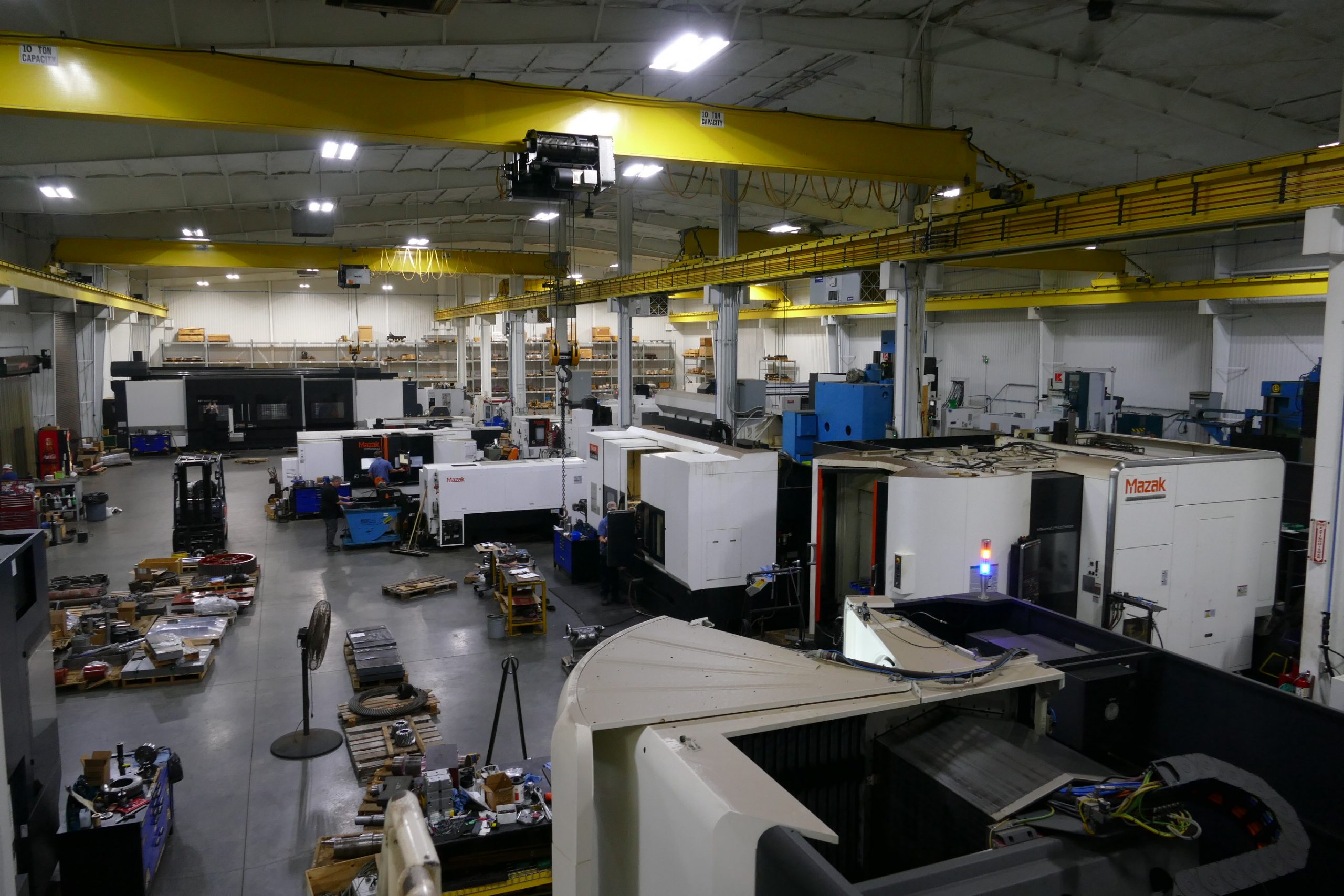 Inside a CNC machine shop with Mazak machining centres and workpieces on the shop floor